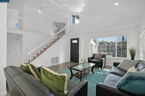 a view of a dining room with furniture and a potted plant