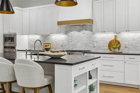 a kitchen with cabinets appliances and a counter space