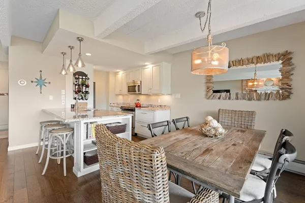 a dining room with furniture a chandelier and wooden floor