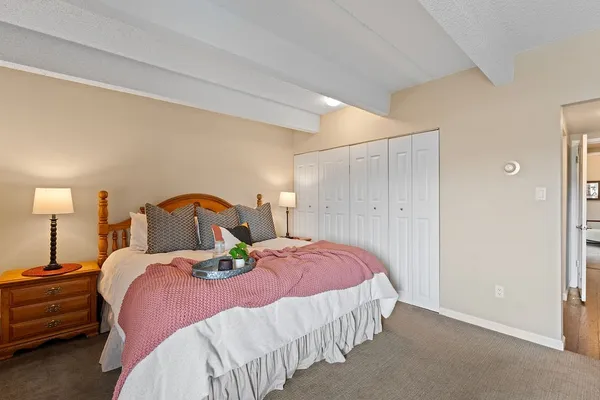a bedroom with a bed and a lamp