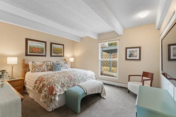 a bedroom with a bed couch and window