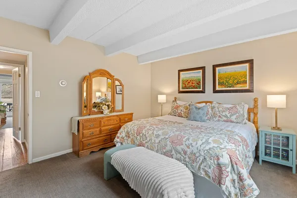 a bedroom with a bed couch and a window