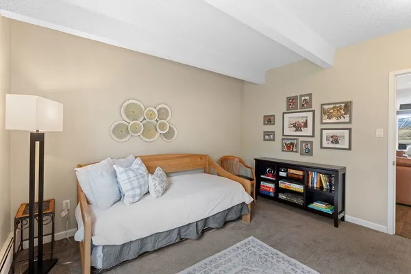 a bedroom with a bed and a night stand