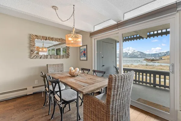a view of a dining room with furniture window and wooden floor