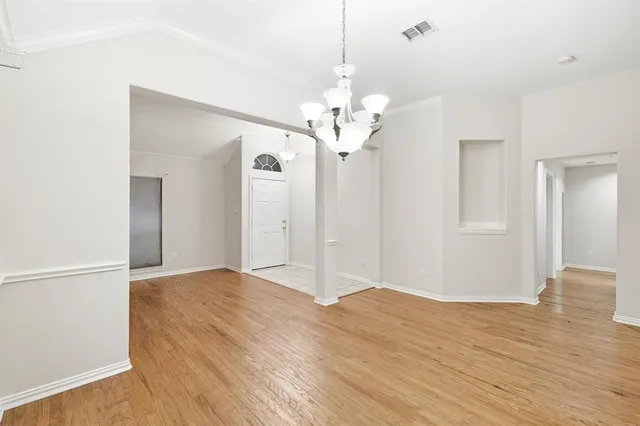 a view of a livingroom with a chandelier fan