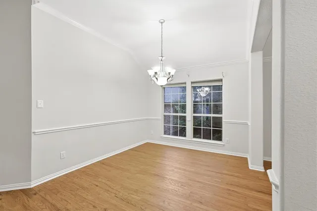 a view of a room with wooden floor and window