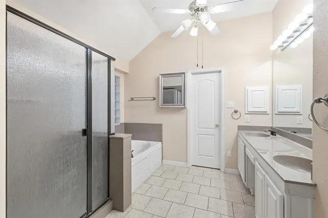 a bathroom with a sink a toilet a mirror and shower