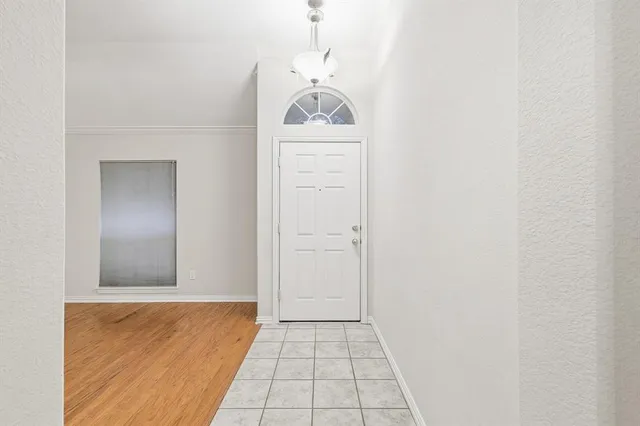 a view of a hallway to closet with wooden floor