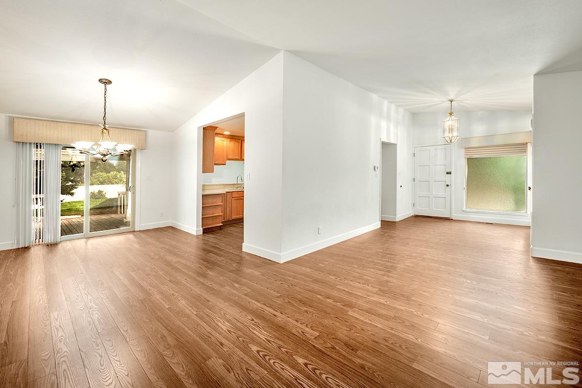 3115 Corey Drive Reno, NV 89509 - Photo 6 of 20 a view of empty room with wooden floor and kitchen view