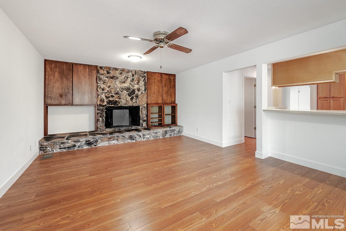 3115 Corey Drive Reno, NV 89509 - Photo 8 of 20 a view of a livingroom with wooden floor a ceiling fan and window