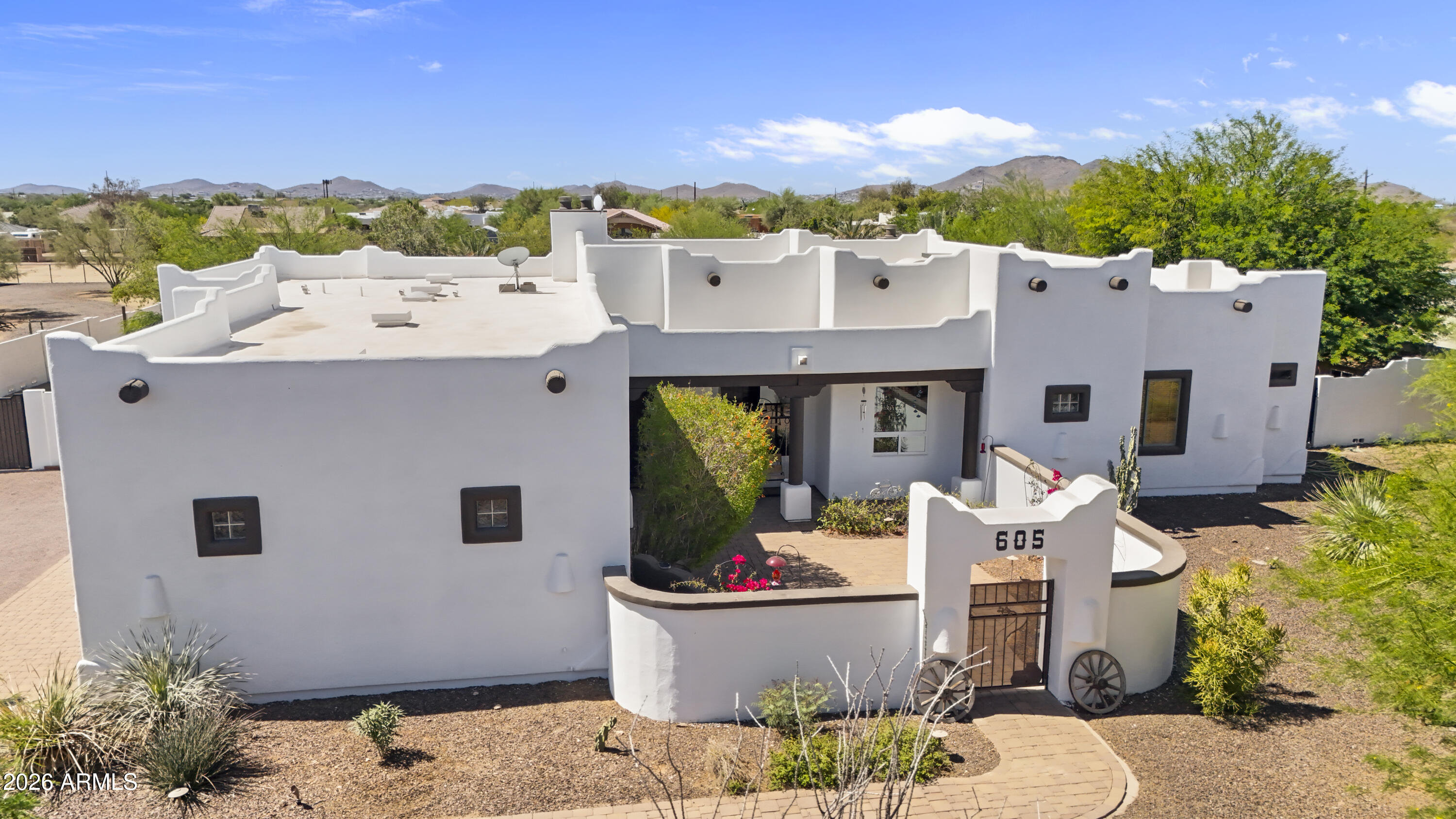 605 West Ridgecrest Road Phoenix, AZ 85086 - Photo 2 of 40 a front view of a house with a fountain and a fire pit