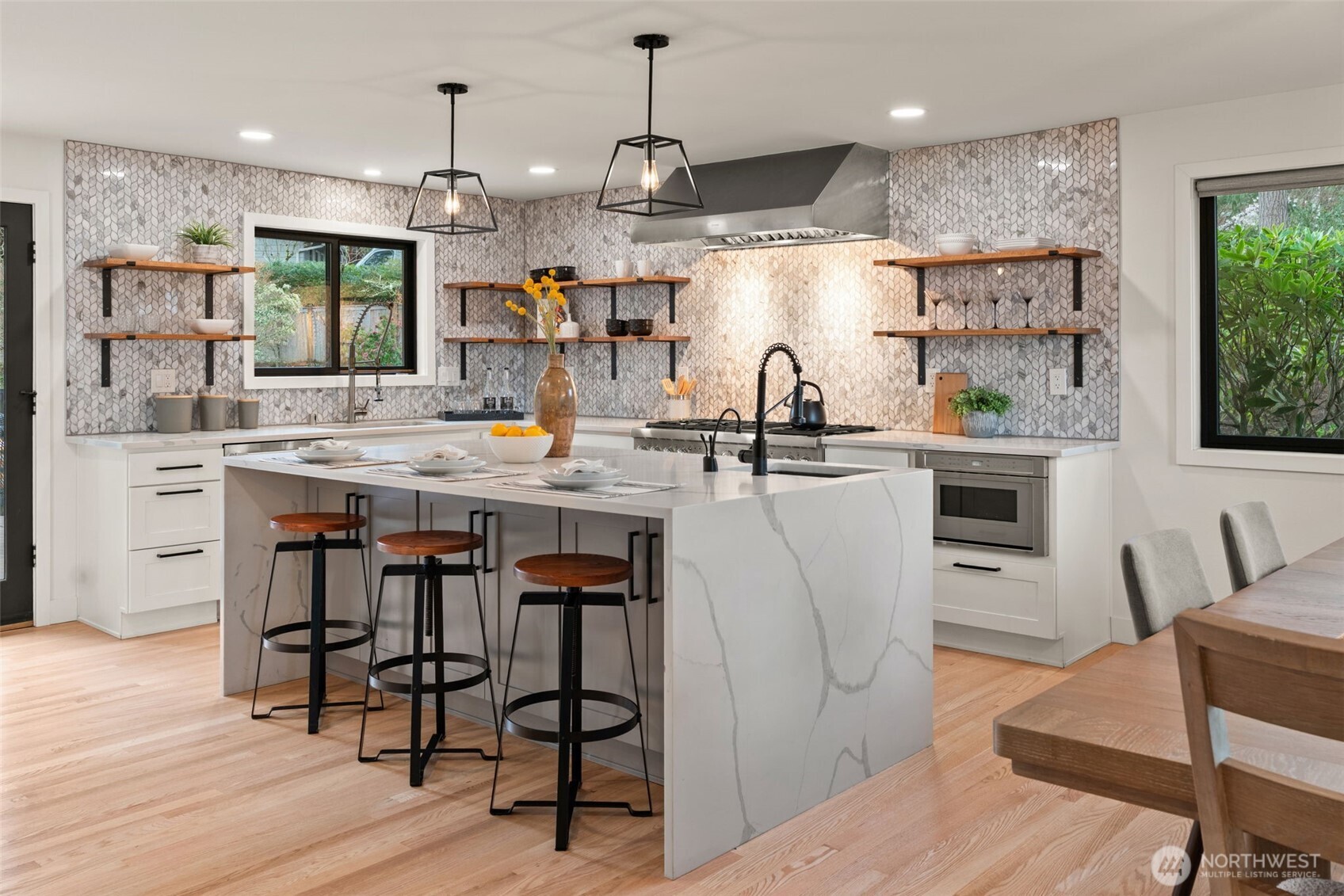 19125 94th Avenue West Edmonds, WA 98020 - Photo 11 of 37 a kitchen with stainless steel appliances granite countertop a kitchen island a stove a table and chairs in it