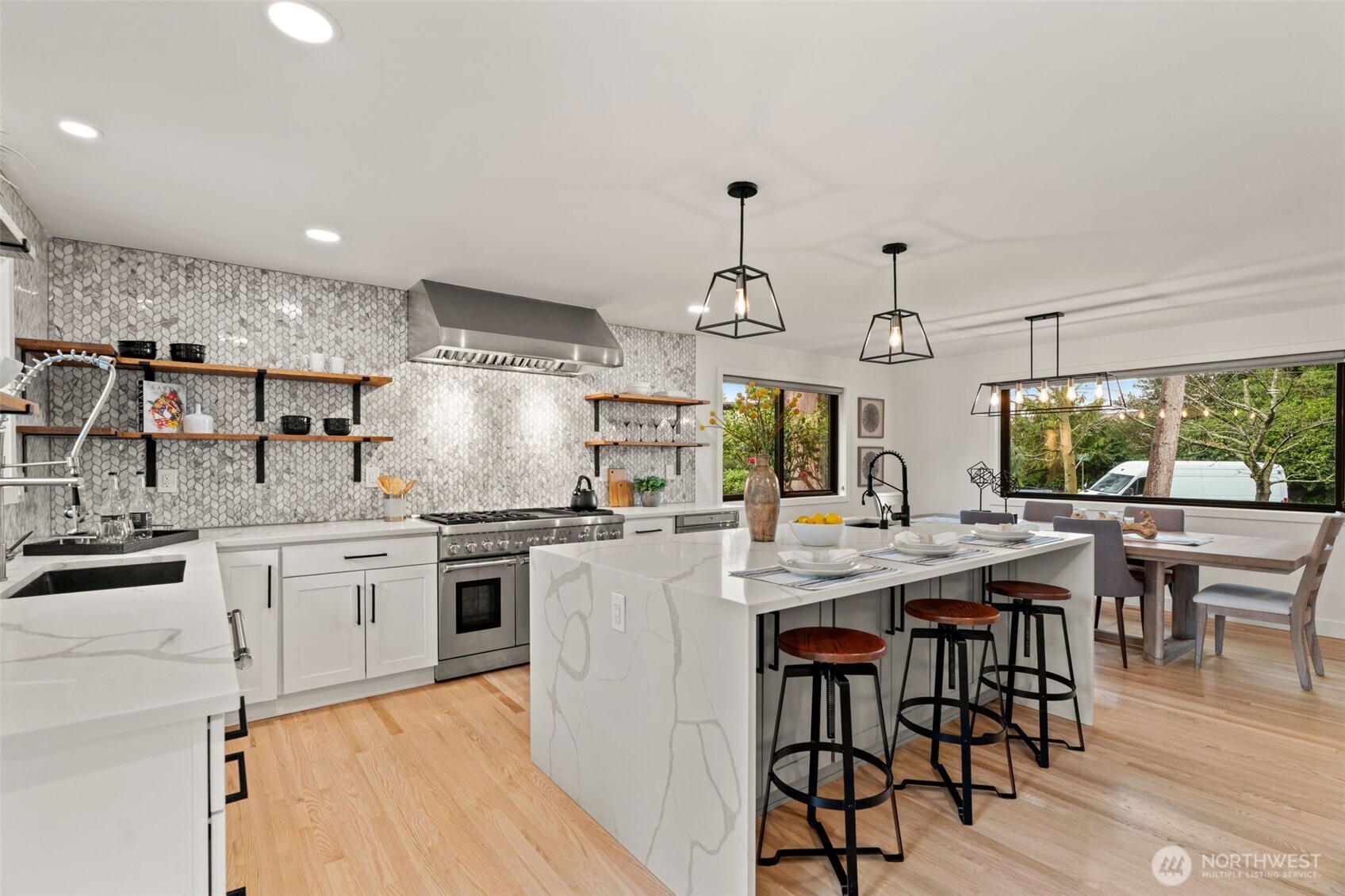 19125 94th Avenue West Edmonds, WA 98020 - Photo 15 of 37 a kitchen with stainless steel appliances granite countertop a stove top oven a sink dishwasher and white cabinets with wooden floor