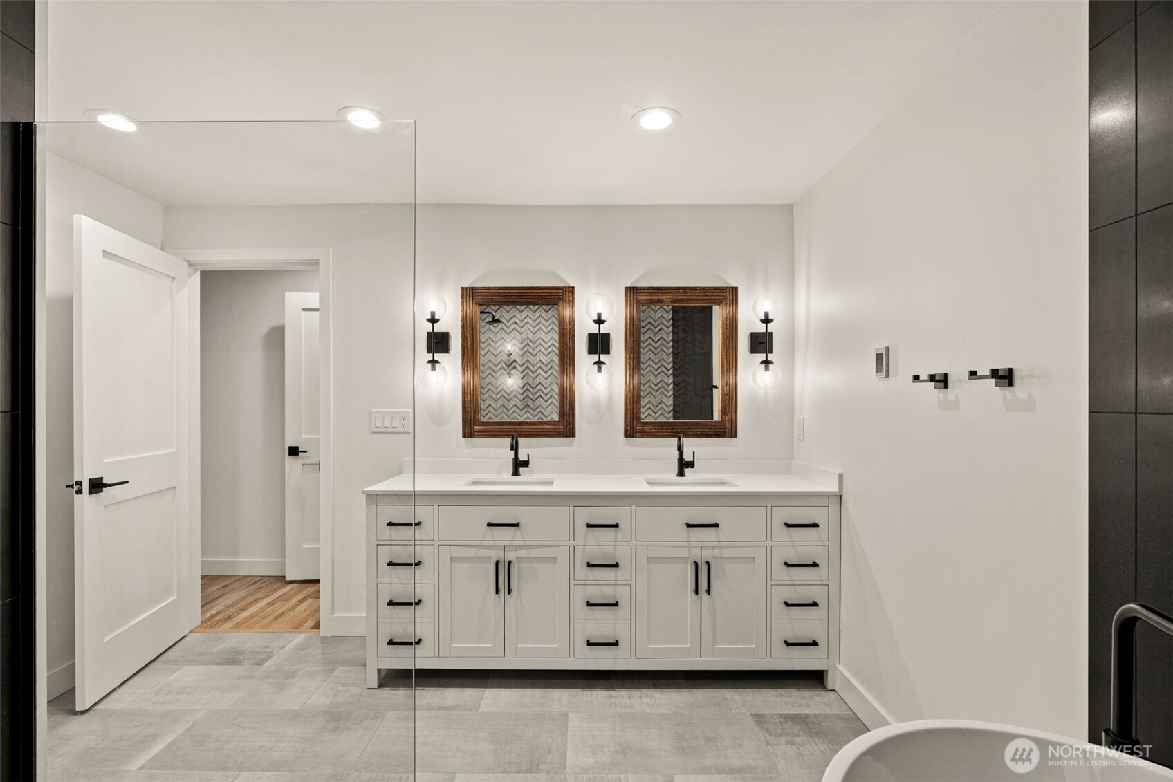 19125 94th Avenue West Edmonds, WA 98020 - Photo 17 of 37 a spacious bathroom with a double vanity sink a mirror and a bathtub