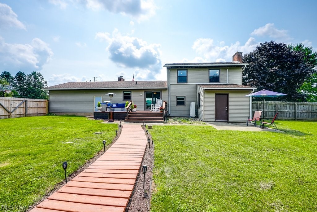 81 Bolender Road Mogadore, OH 44260 - Photo 27 of 35 Rear view of property featuring a patio, a deck, and a yard