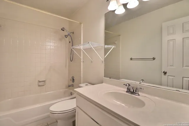 a bathroom with a sink toilet tub and shower