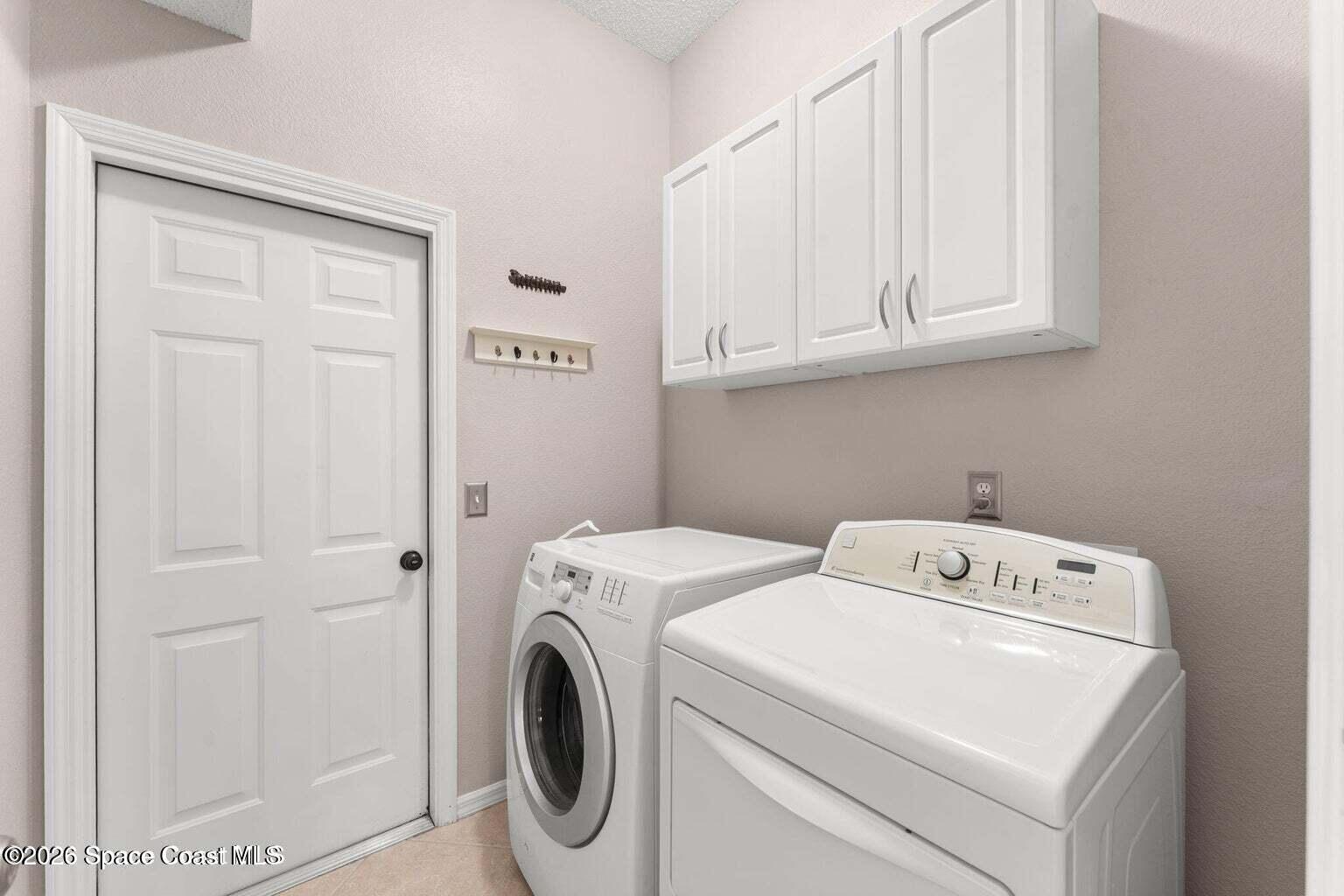 4741 Decatur Circle Melbourne, FL 32934 - Photo 24 of 44 a utility room with dryer and washer