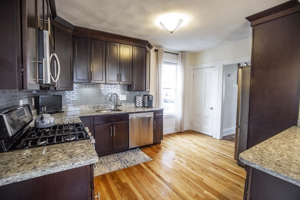 10 Columbus Avenue Saugus, MA 01906 - Photo 13 of 38 a kitchen with stainless steel appliances granite countertop a stove a sink and a refrigerator