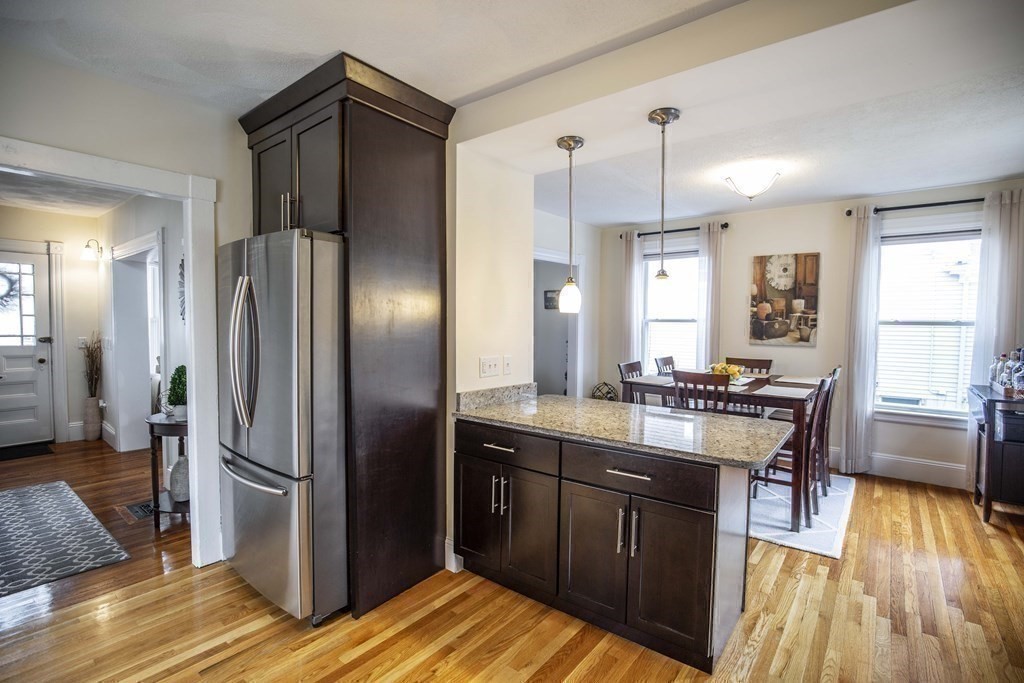 10 Columbus Avenue Saugus, MA 01906 - Photo 15 of 38 a kitchen with stainless steel appliances granite countertop a refrigerator a sink dishwasher a stove and white countertops with wooden floor