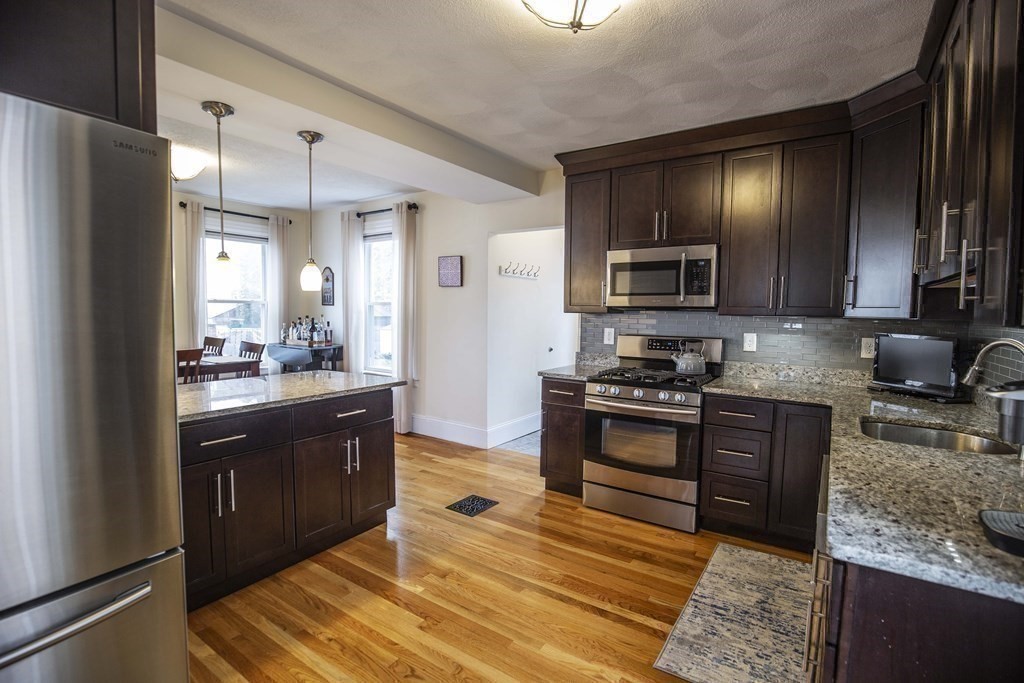 10 Columbus Avenue Saugus, MA 01906 - Photo 16 of 38 a kitchen with stainless steel appliances granite countertop a refrigerator stove and sink
