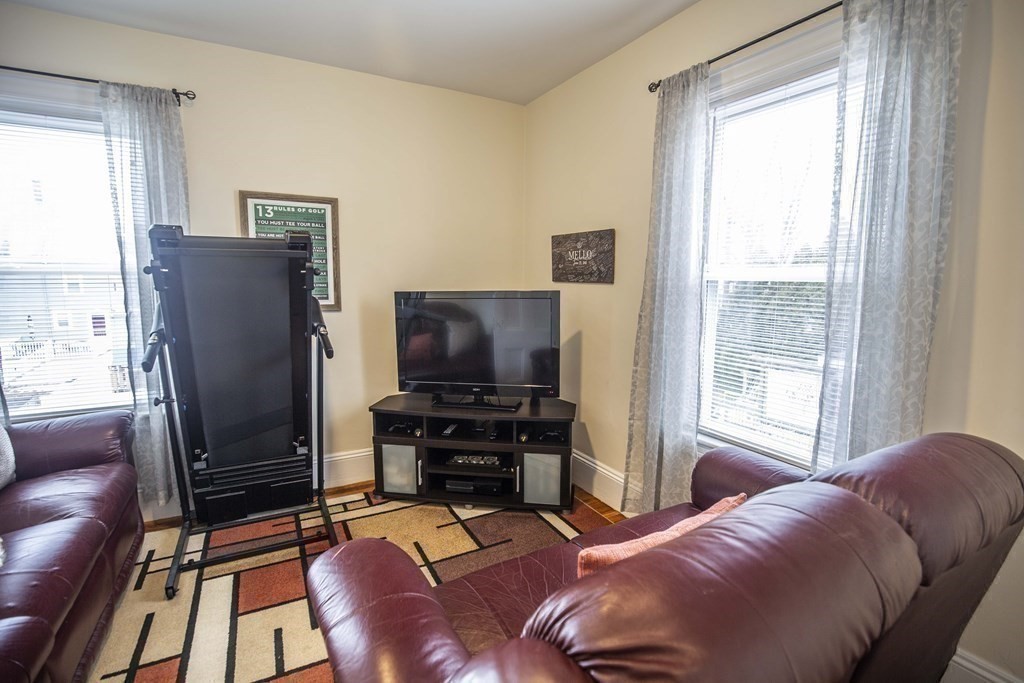10 Columbus Avenue Saugus, MA 01906 - Photo 22 of 38 a living room with furniture and a flat screen tv