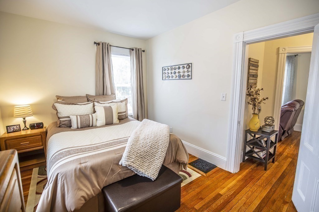 10 Columbus Avenue Saugus, MA 01906 - Photo 24 of 38 a bedroom with a bed and wooden floor