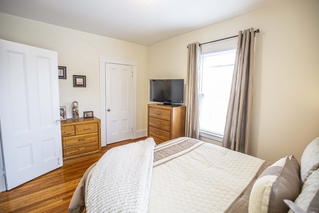 10 Columbus Avenue Saugus, MA 01906 - Photo 25 of 38 a bedroom with a bed and wooden floor