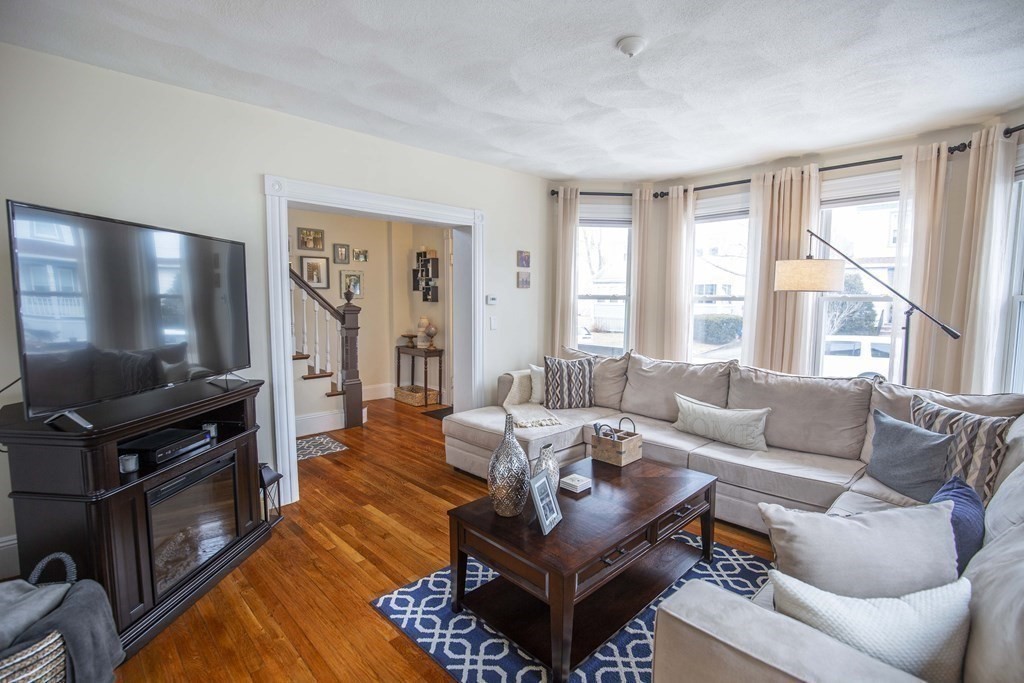 10 Columbus Avenue Saugus, MA 01906 - Photo 7 of 38 a living room with furniture a flat screen tv and a large window