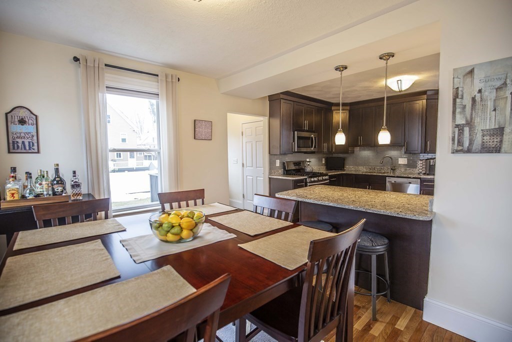 10 Columbus Avenue Saugus, MA 01906 - Photo 10 of 38 a kitchen with a table and chairs in it