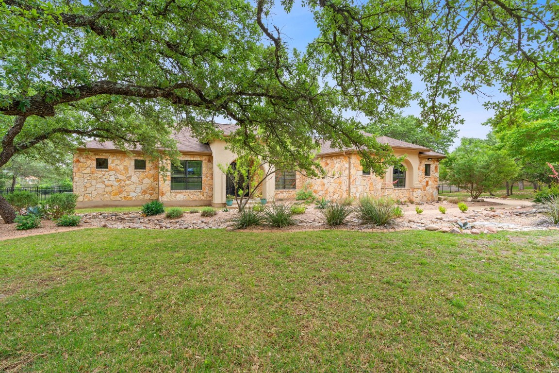 a front view of house with yard and green space