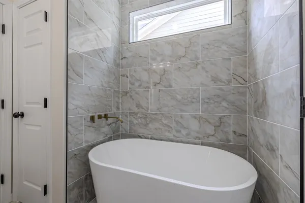 a white bath tub sitting next to a white sink