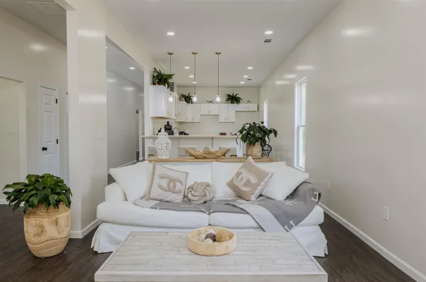 a living room with furniture and a chandelier