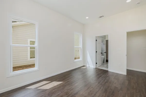 a view of a livingroom with wooden floor and window