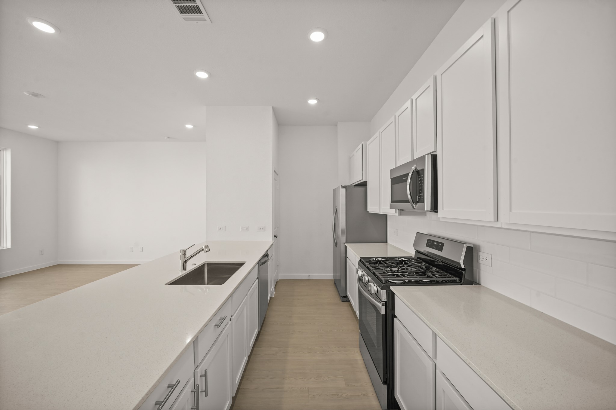 2207 Diagonal Lane Houston, TX 77051 - Photo 25 of 36 a kitchen with stainless steel appliances a sink stove and white cabinets