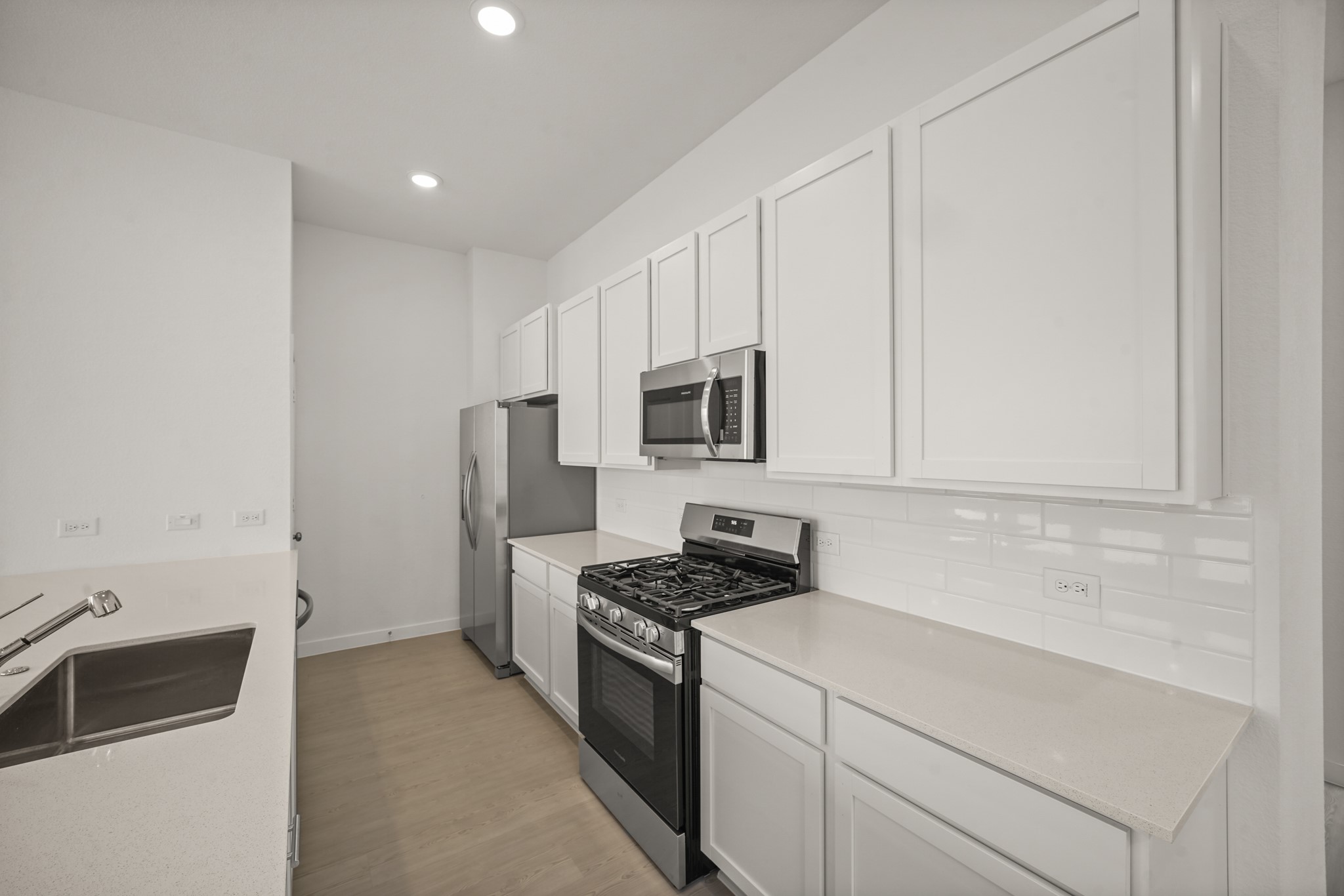 2207 Diagonal Lane Houston, TX 77051 - Photo 26 of 36 a kitchen with white cabinets and stainless steel appliances