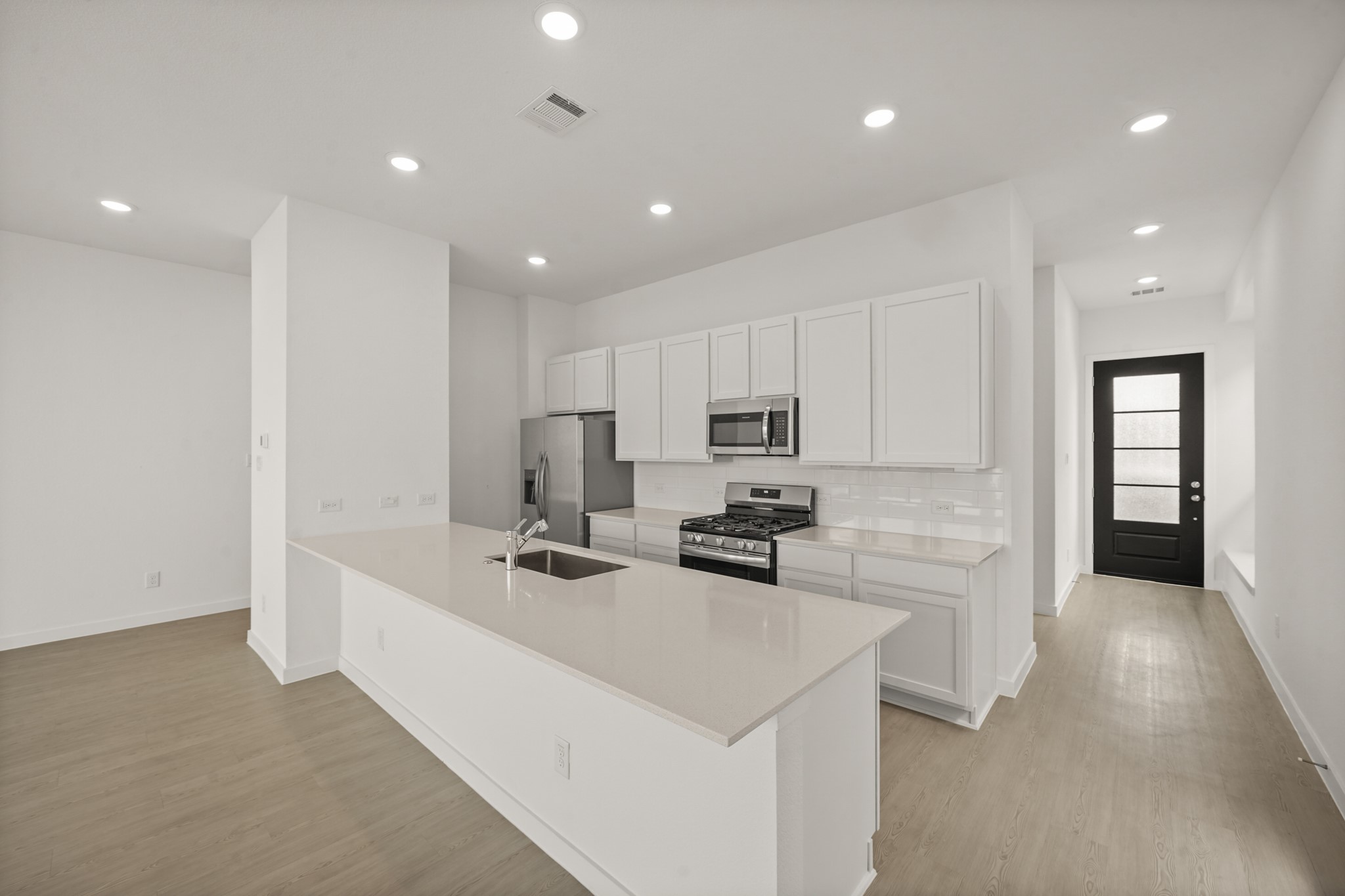 2207 Diagonal Lane Houston, TX 77051 - Photo 27 of 36 a kitchen with stainless steel appliances a stove top oven a refrigerator a sink and white cabinets