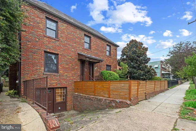 a view of a brick house with many windows