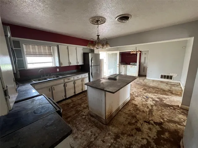 a kitchen with stainless steel appliances granite countertop a sink and a stove