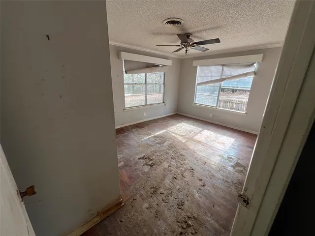 an empty room with windows and closet