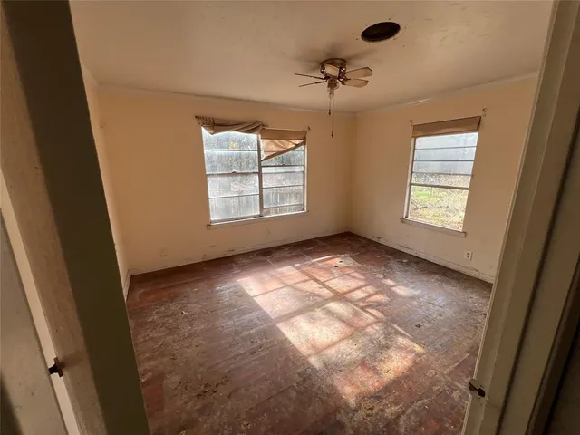 a view of an empty room and a window