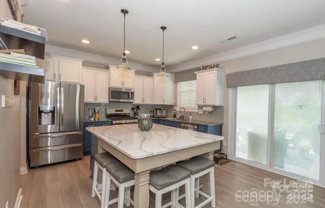 a kitchen with refrigerator a sink and a stove