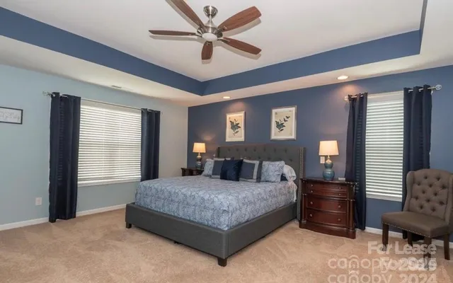 a bedroom with a bed and dresser with wooden floor