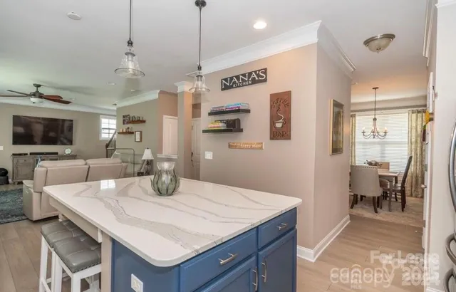 a kitchen with a table chairs refrigerator and microwave