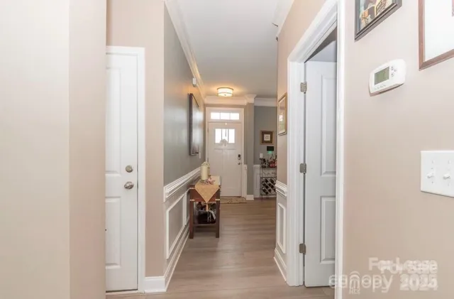 a view of a hallway with a livingroom and a bathroom with a sink