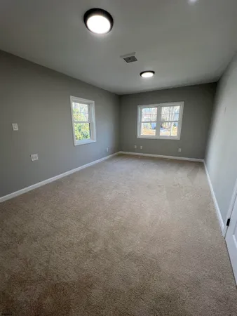 a view of a field of grass and trees