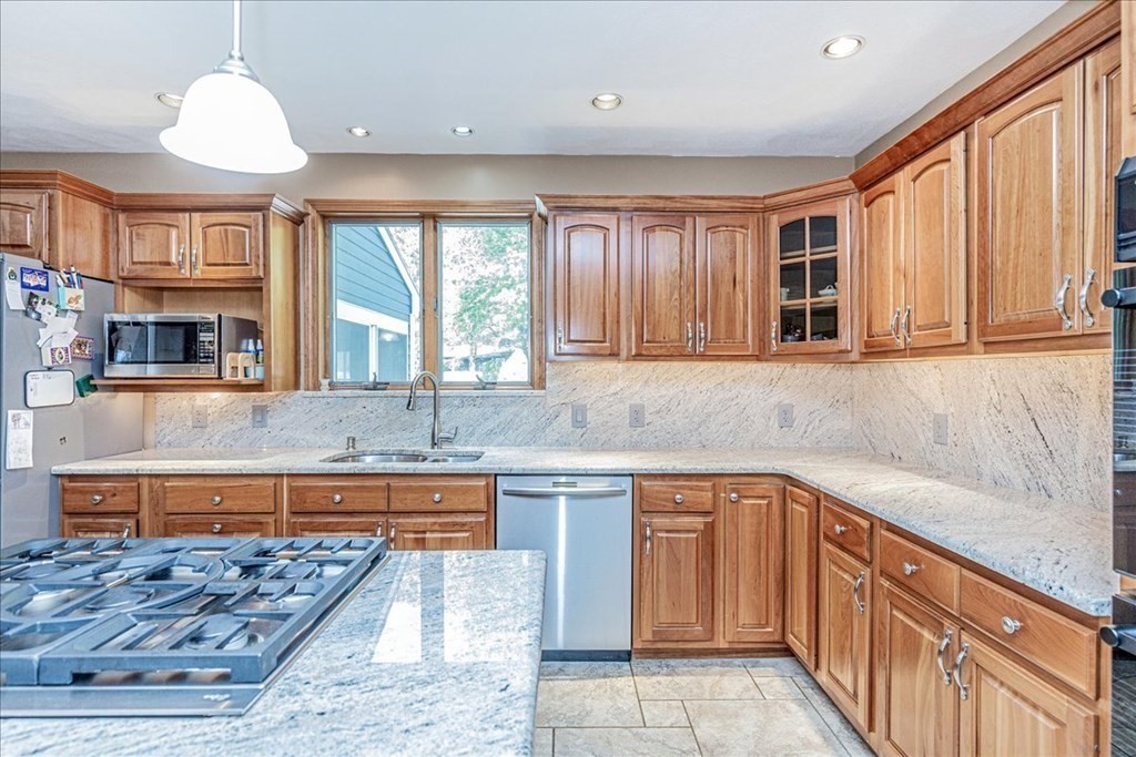 24 Campbell Road Middleton, MA 01949 - Photo 20 of 41 a kitchen with stainless steel appliances granite countertop a sink and wooden cabinets
