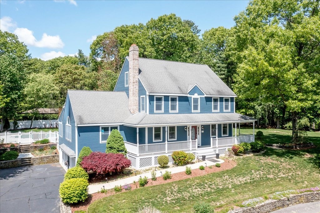 24 Campbell Road Middleton, MA 01949 - Photo 3 of 41 a front view of a house with a yard table and chairs