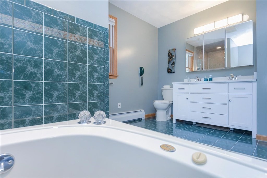 24 Campbell Road Middleton, MA 01949 - Photo 32 of 41 a bathroom with a sink a toilet a mirror and bathtub