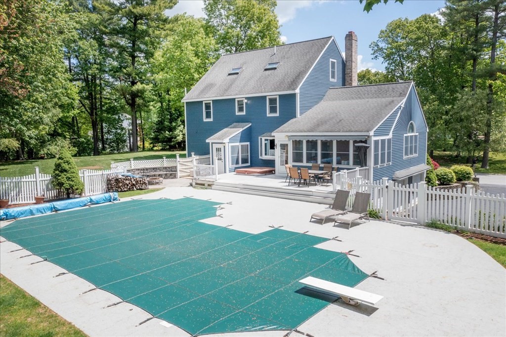 24 Campbell Road Middleton, MA 01949 - Photo 5 of 41 a front view of a house with a yard table and chairs