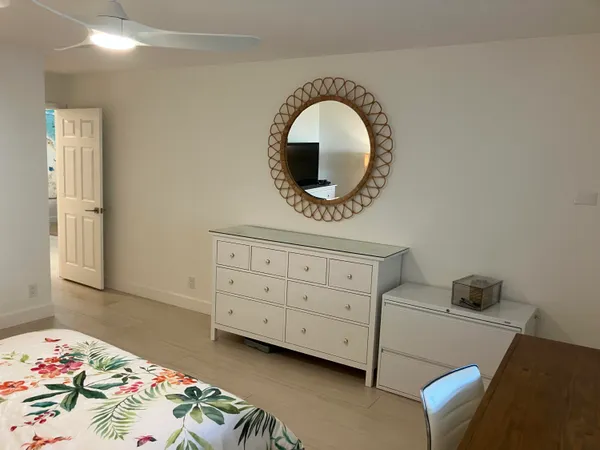 a bedroom with a bed and a dresser